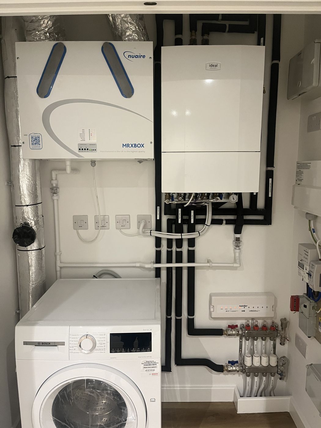 Apartment plant cupboard — boiler, MVHR and UFH manifold